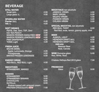 a chalkboard menu with two glasses of wine and a bottle of champagne